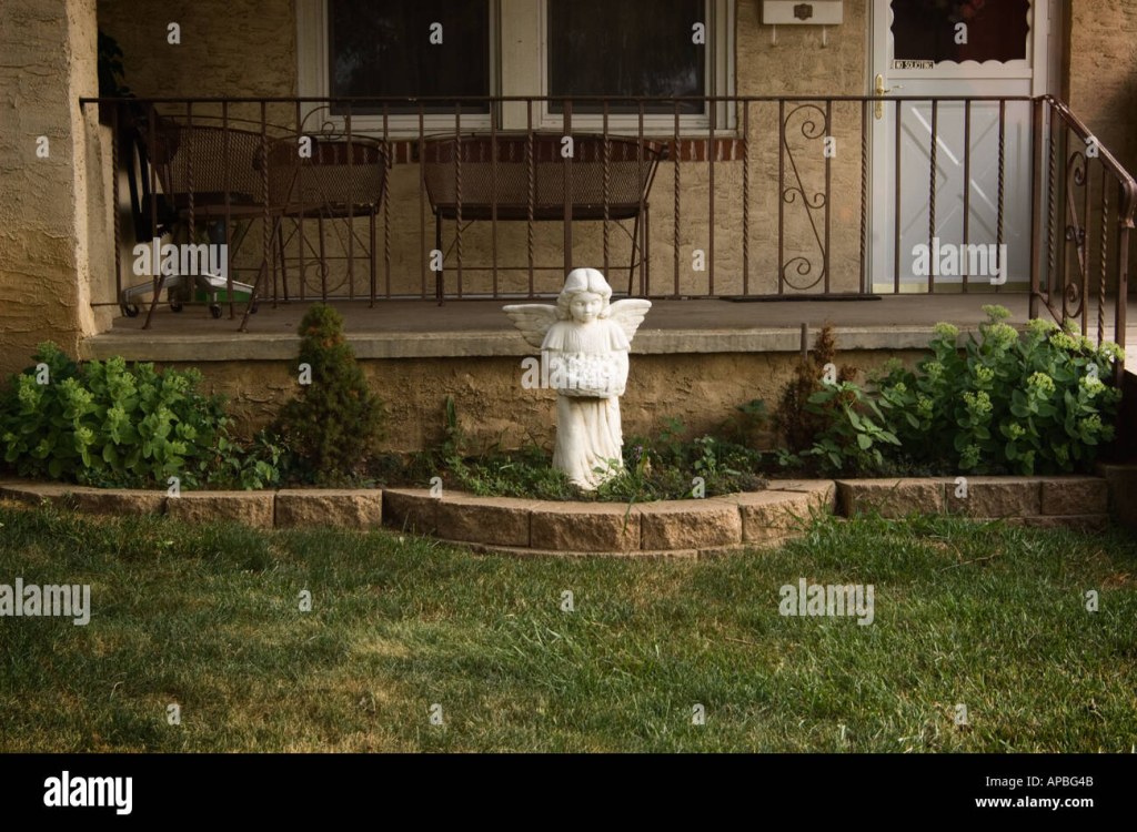 Picture of: front yard and front porch of a middle class house with an angel