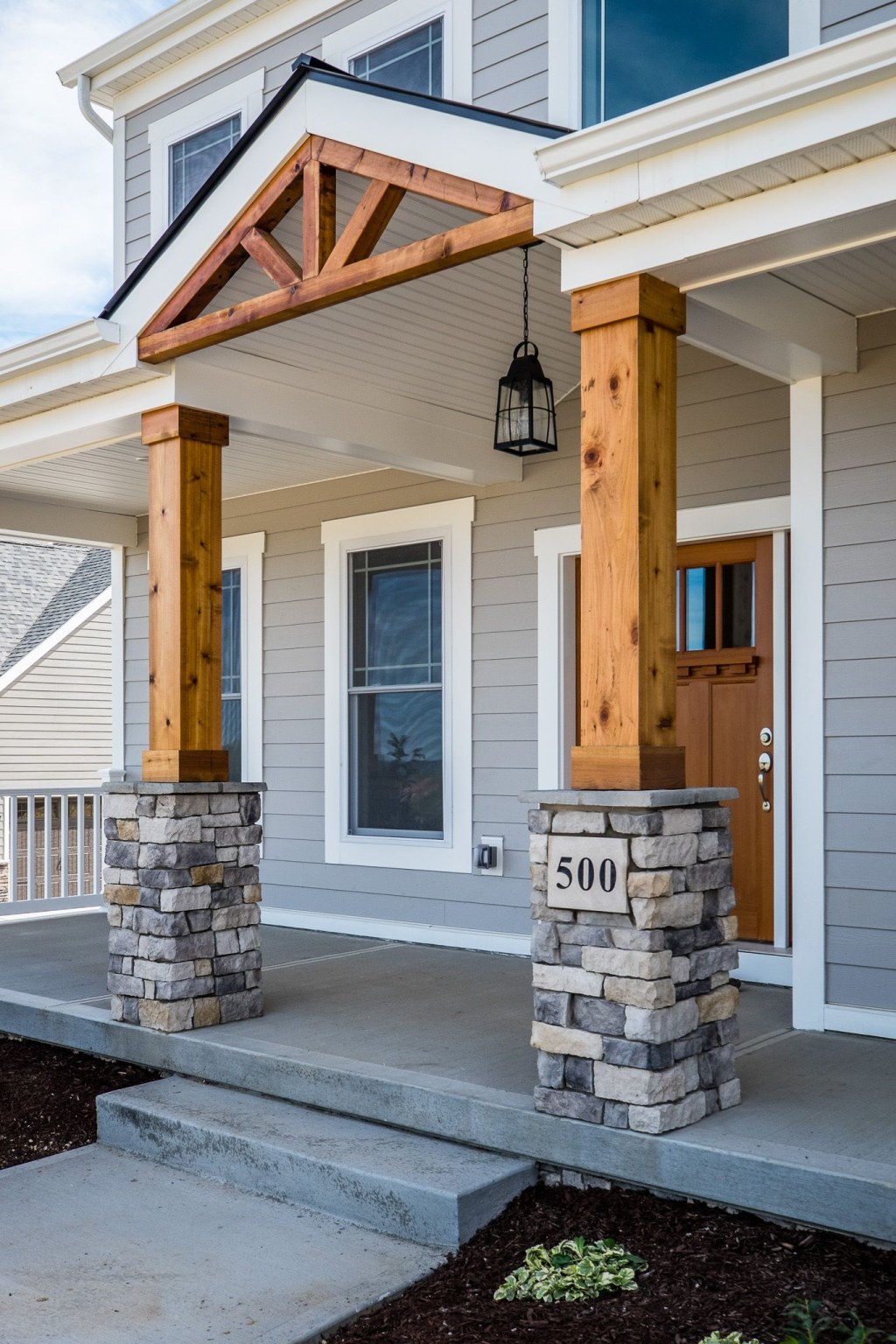 Picture of: Gorgeous Front Porch! Wood and Stone Columns!  House with porch